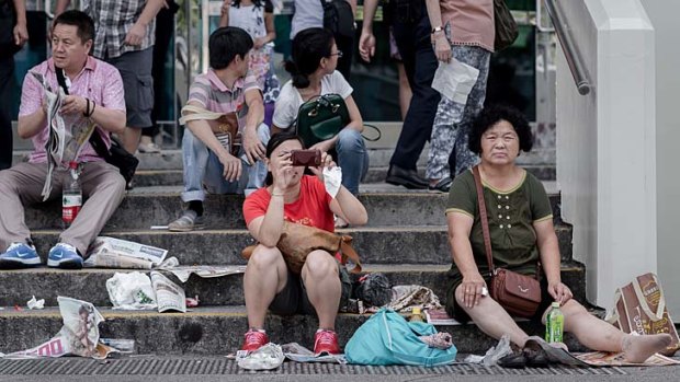 Chinese tourists visit a popular waterfront promenade in Hong Kong.