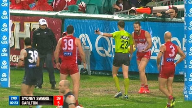 Nick Malceski looks on in disbelief as an umpire awards a free kick to Carlton for a deliberate rushed behind.