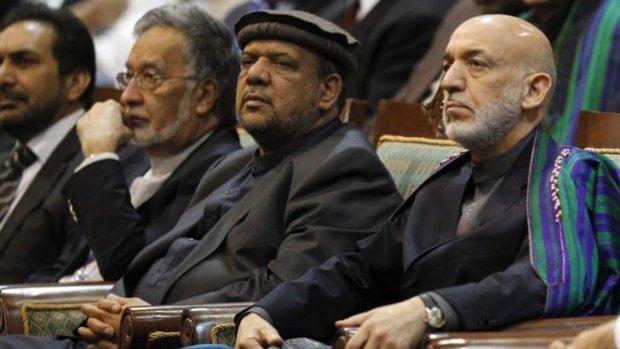 Power broker: Mohammed Qasim Fahim (centre) with Afghan President Hamid Karzai (right) in November 2013.