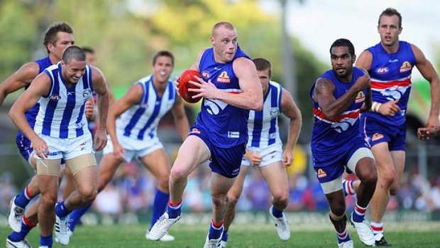 Adam Cooney of the Western Bulldogs breaks free of the pack during the practice match against North Melbourne  at  Ballarat yesterday.