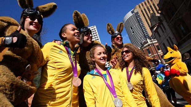 Liz Cambage, left, Brittany Broben, centre, and Jessica Fox during the welcome home parade in Sydney.