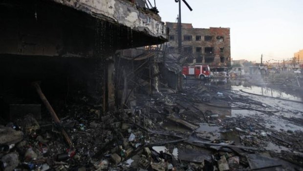 The never-ending tide of death: A destroyed building after a car bomb attack in Baghdad on September 11, 2014. 
