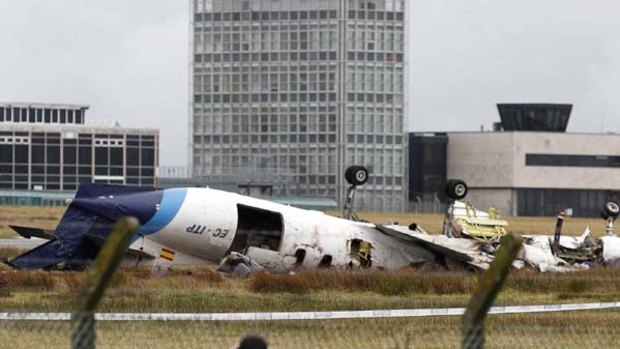 Six dead ... a commuter plane lies upside down at Cork Airport.