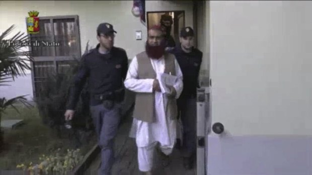 Italian Policemen detain a man suspected to be member of an armed organisation inspired by al-Qaeda in this still image taken from a video released by Italian Police. 