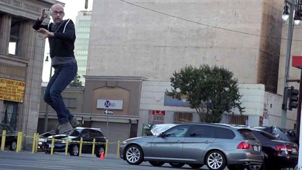 Musician Moby riding a fake hoverboard.