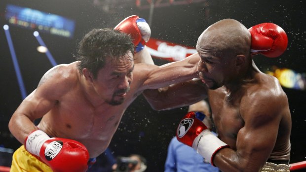 Manny Pacquiao, left, trades blows with Mayweather during their Las Vegas bout.