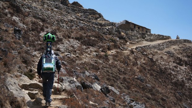 A member of the Google Street View project walks with the camera used to capture project footage through Nepal's Khumbu region.