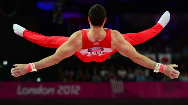 Bronze medallist ... Great Britain's Kristian Thomas competes at the horizontal bar during the men's team final.