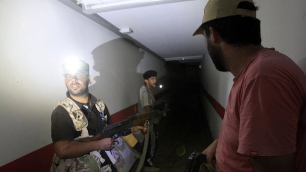 Rebel fighters inspect a tunnel in the Gaddafi compound.