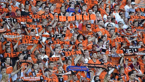 Roar fans show their colours during the match against the Central Coast Mariners at Suncorp Stadium on Sunday.