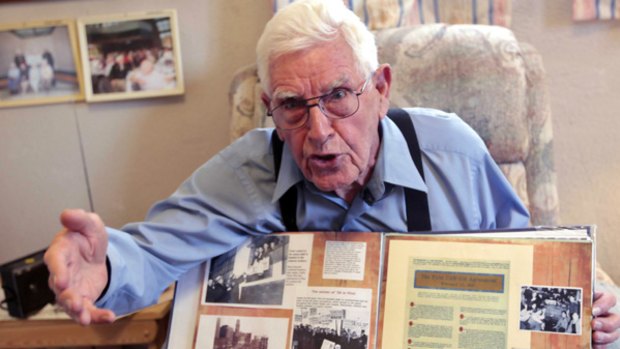 Ninety-one-year-old Olen Ham with photos of his time at General Motors.
