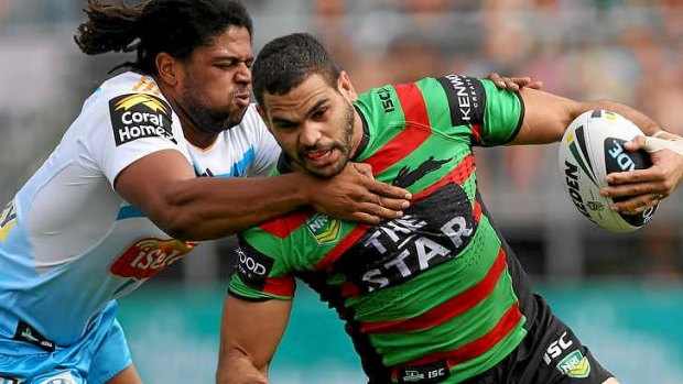 No easy ask: Gold Coast's Jamal Idris moves in to tackle South Sydney's Greg Inglis in Cairns on Sunday.