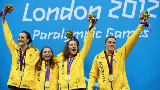 Australia's Ellie Cole (left), Madison Elliot, Katherine Downie and Jacqueline Freney celebrate on the podium after winning the women's 4x100 freestyle relay at the London 2012 Paralympic Games.