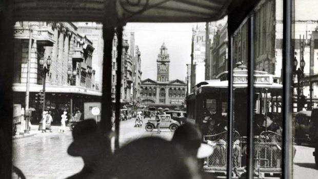 A tram approaches Flinders Street Station as another heads for Brunswick.