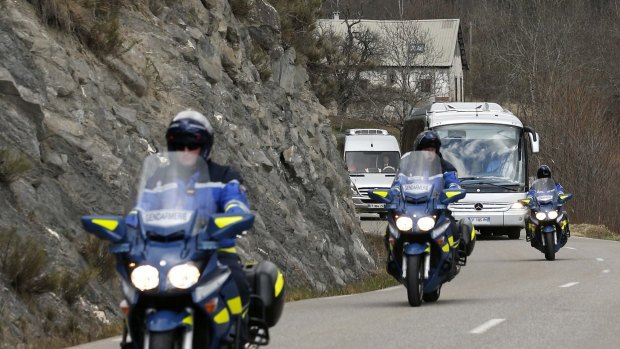 A coach transporting family members and relatives of the victims is escorted by French Gendarmes as they arrive in Seyne-les-Alpes near the crash site of an Airbus A320 in the French Alps.