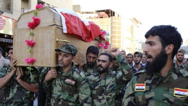 Mourners carry the coffin of a Shi'ite volunteer from the brigades of peace, who joined the Iraqi army and was killed during clashes with militants of the Islamic State, formerly known as the Islamic State in Iraq and the Levant (ISIL) in Samarra.