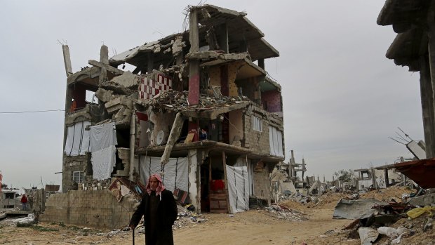 A elderly Palestinian this week walks past a building in Gaza damaged in last summer's Israel-Hamas war.