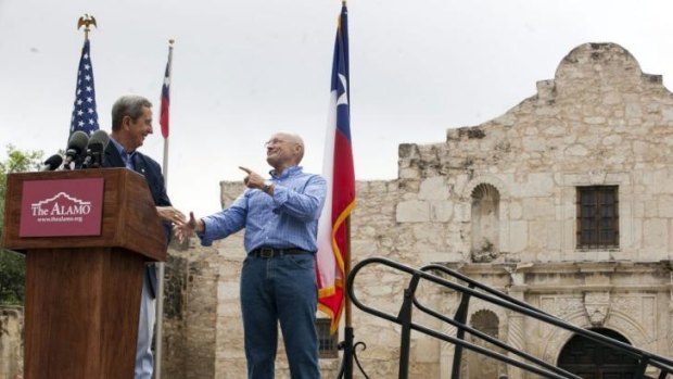 Texas Land Commissioner Jerry Patterson, left, greets Phil Collins in front of the Alamo.