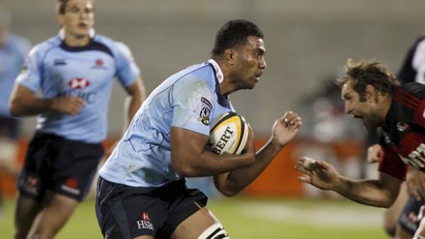Missing piece ... Waratahs back-rower Wycliff Palu is confronted by George Whitelock of the Crusaders on Saturday night. Palu later hurt his knee and is out for the season.