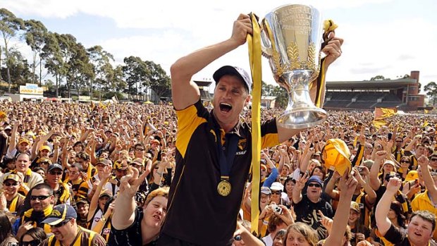 Hawthorn's Shane Crawford holds the cup at Glenferrie Oval after the club's 2008 premiership.