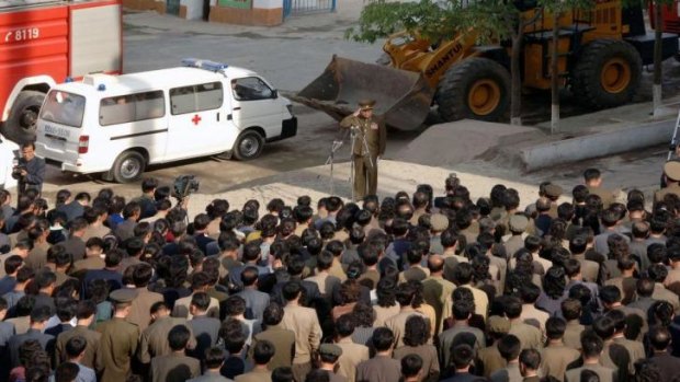 A construction officer apologises after the building collapse, in this photo released by  North Korea's state-run media.