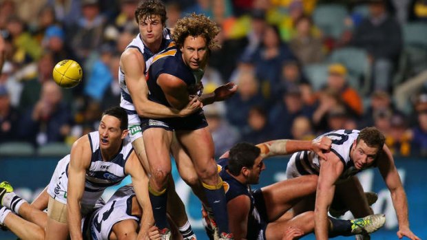 Jordan Murdoch of the Cats tackles Matt Priddis at Patersons Stadium.