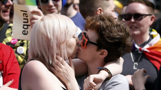 Same-sex marriage supporters kiss at Dublin Castle in Dublin on Saturday following the referendum to legalise same-sex marriage.