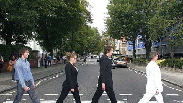 Hallowed round ... Beatles fans cross Abbey Road.