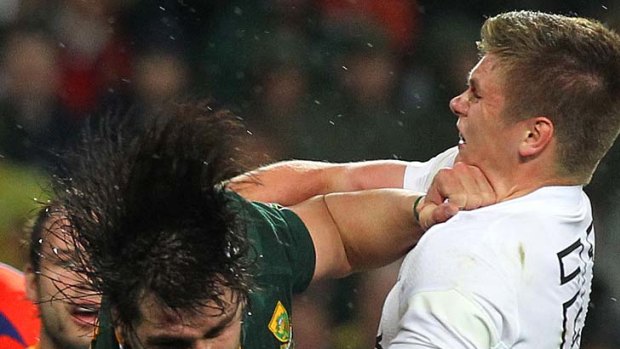 Heavy collision ... Jacques Potgieter of South Africa is tackled by Owen Farrell.