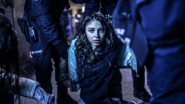 A young girl, wounded during clashes between riot police and protesters.