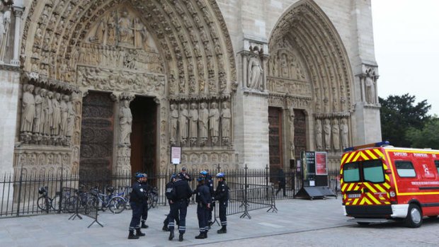 French policemen stand outside Notre Dame Cathedral.