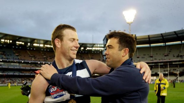 Cats coach Chris Scott acknowledges the efforts of injured forward Steve Johnson after the 2011 grand final.