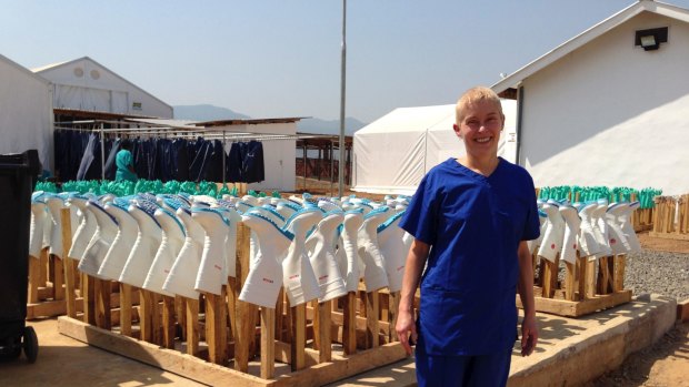 Dr Bernie Towler stands in front of an array of disinfected gumboots at the Ebola Treatment Centre in Sierra Leone.