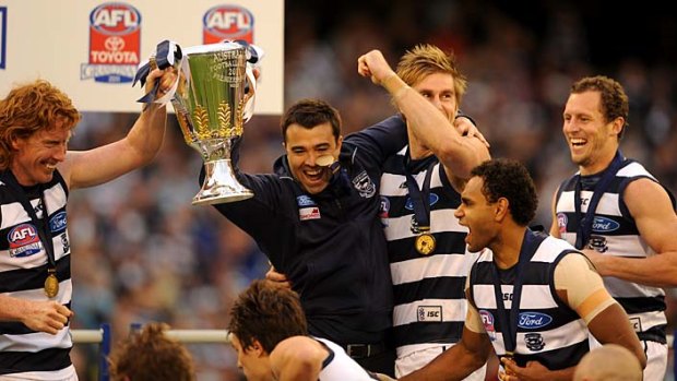 Whooping it up: Geelong players enjoy their big moment after Saturday's grand final win.