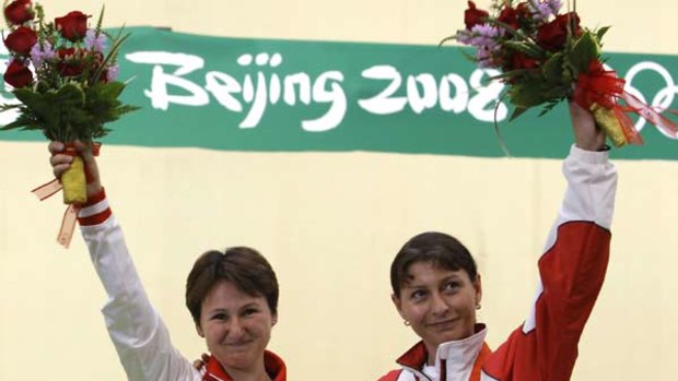 Russia's Natalia Paderina, left, and Georgia's Nino Salukvadze happily share the podium after yesterday's shooting event.