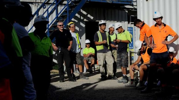Norman MacLachlan, ACT construction manager for Project Coordination (black shirt) stands with his workers  from the Aurora apartments when the union inspected the site last week.