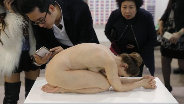 Visitors take photos of "Untitled (Kneeling Woman)", by Australian artist Sam Jinks, was popular at Art Basel Hong Kong.