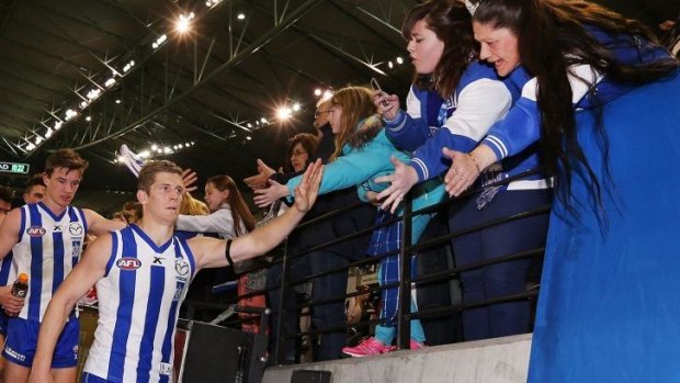 Nick Dal Santo high-fives fans after the game.