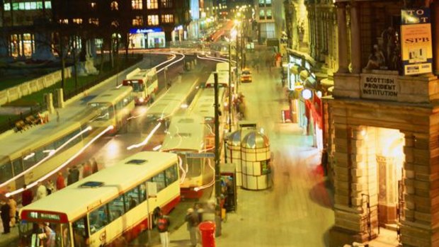 Buses in Donegall Square North at night.