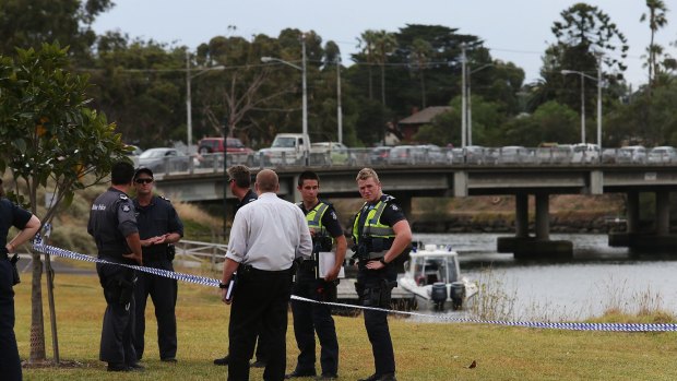 Police at the Maribyrnong River where body parts have been found.
