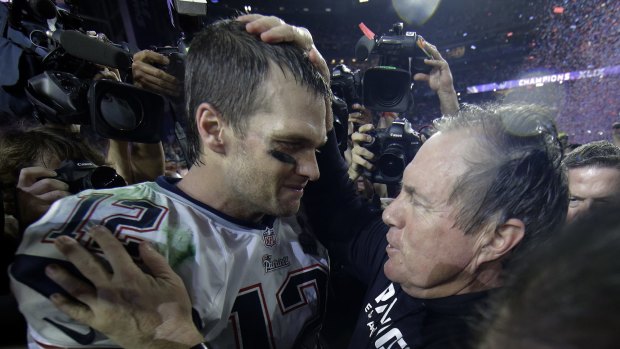 Big show: New England Patriots quarterback Tom Brady celebrates with head coach Bill Belichick after winning last year's Super Bowl.