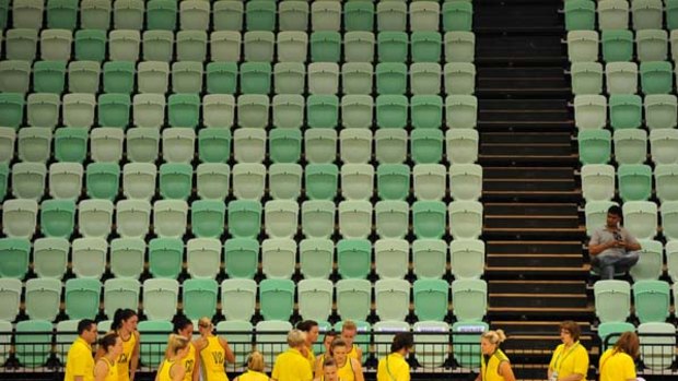 The Australian netball team warms up before their clash with Samoa in front of a near-empty stand.