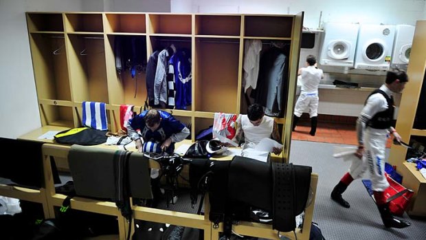 Inner sanctum: The jockeys' room at Caulfield is a busy place as riders prepare for their next mount.