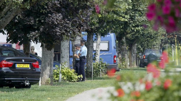 French police investigate at a nearby camping ground on the day after the killings.