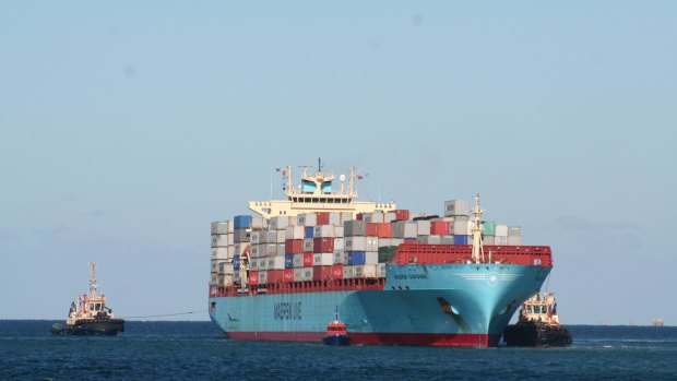 Tugs try to free the container ship Maersk Garonne after it ran aground in Fremantle Harbour.