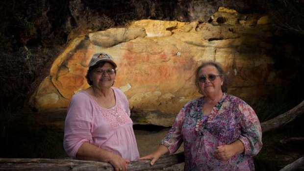 "It's our health, it's our wealth" ... Anita Selwyn and Barbara Grew in front of a cave with Aboriginal hand stencils at Peats Ridge.