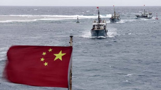 Casting the net wide &#8230; Chinese fishing ships sail through Meiji reef, in the disputed Spratly Islands, this month.