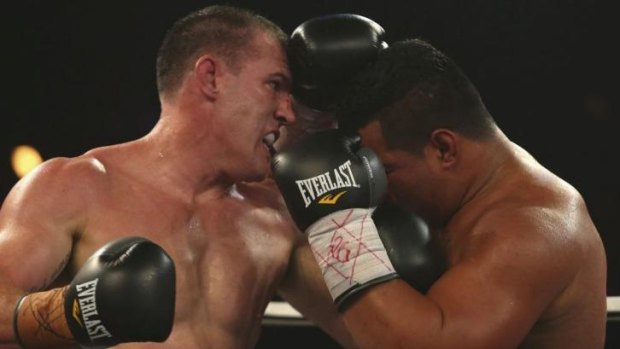 Paul Gallen punches Herman Purcell during their bout on February 19.