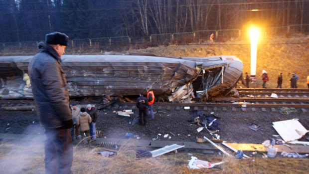 Russian rescue officials examine the wreckage of a train carriage on a line between St Petersburg and Moscow yesterday.