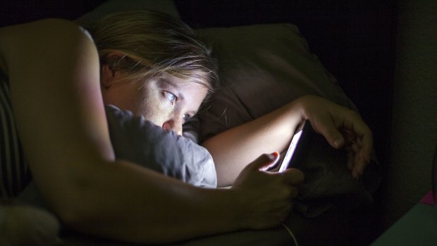 Caucasian woman using cell phone in bed Social media addiction